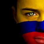 Portrait of a boy with the flag of Colombia painted on his face