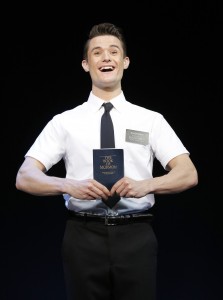 Mark Evans' The Book of Mormon, actor on stage holding the book of mormon, Toronto, Ontario