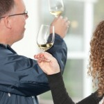 Wine tasting Niagara, man and woman checking white wine for clarity