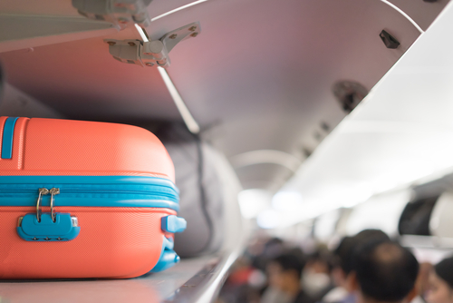 Travel Hacks. 4 Mistakes to avoid on your next trip abroad. TheSceneinTO.com Luggage on plane. shutterstock